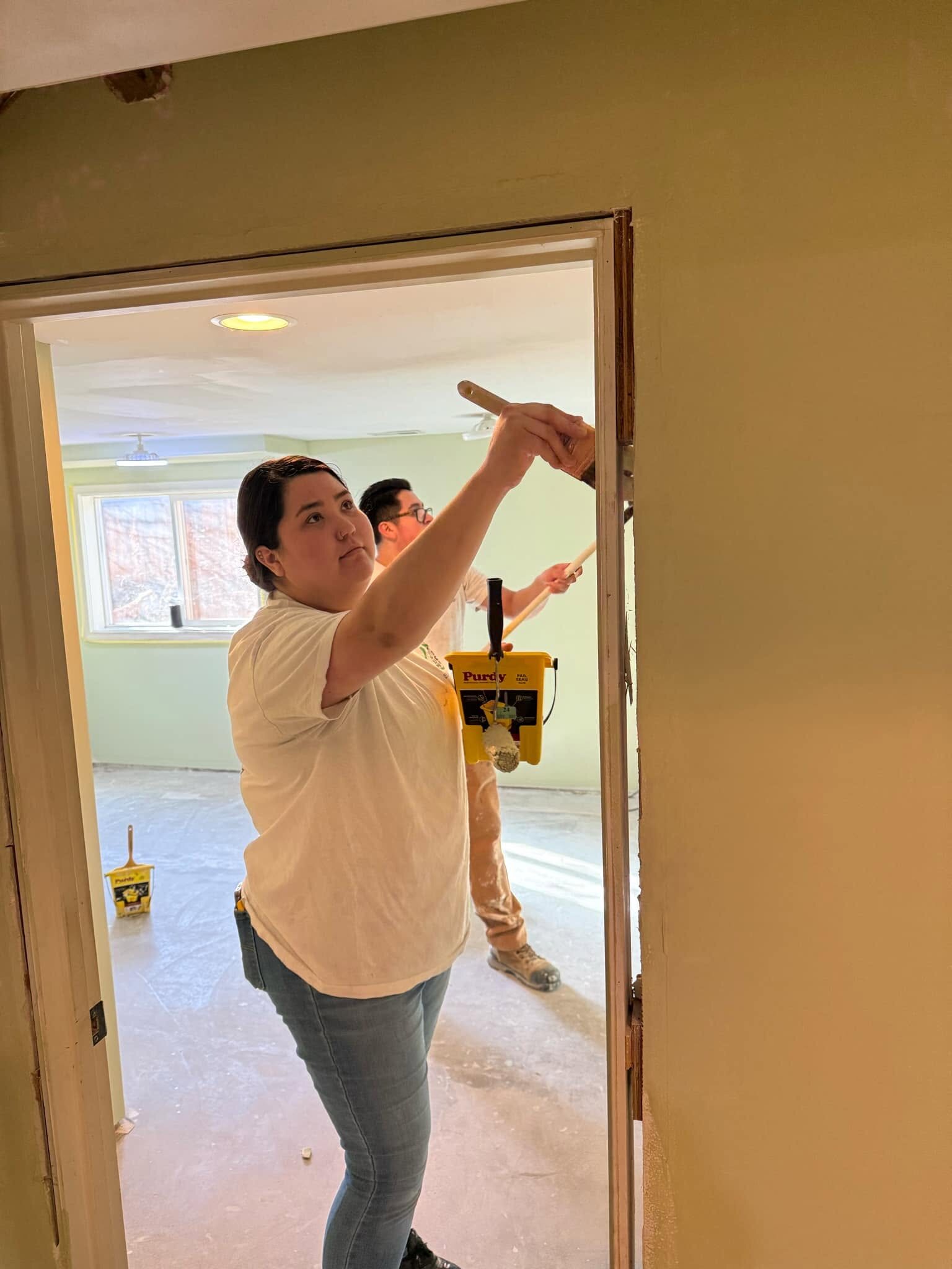 A family member rolling paint