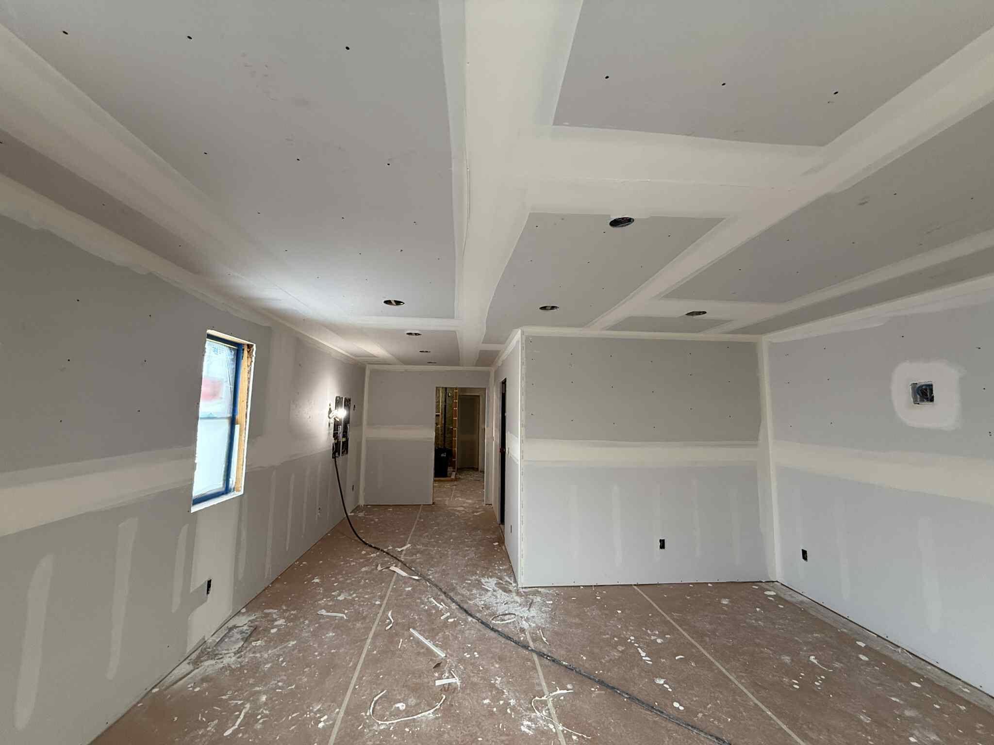 Taped drywall around exposed beams