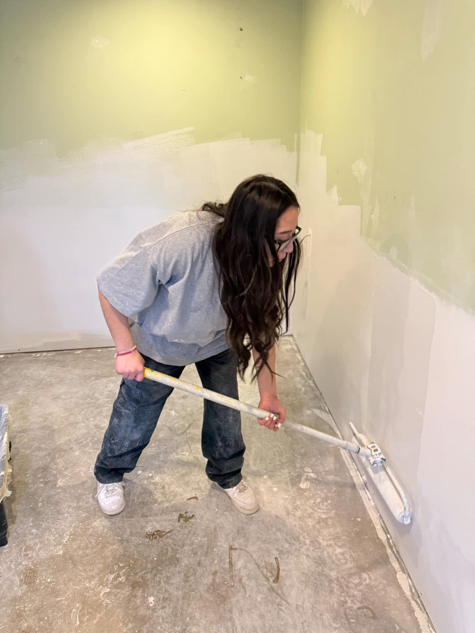 A family member painting a wall