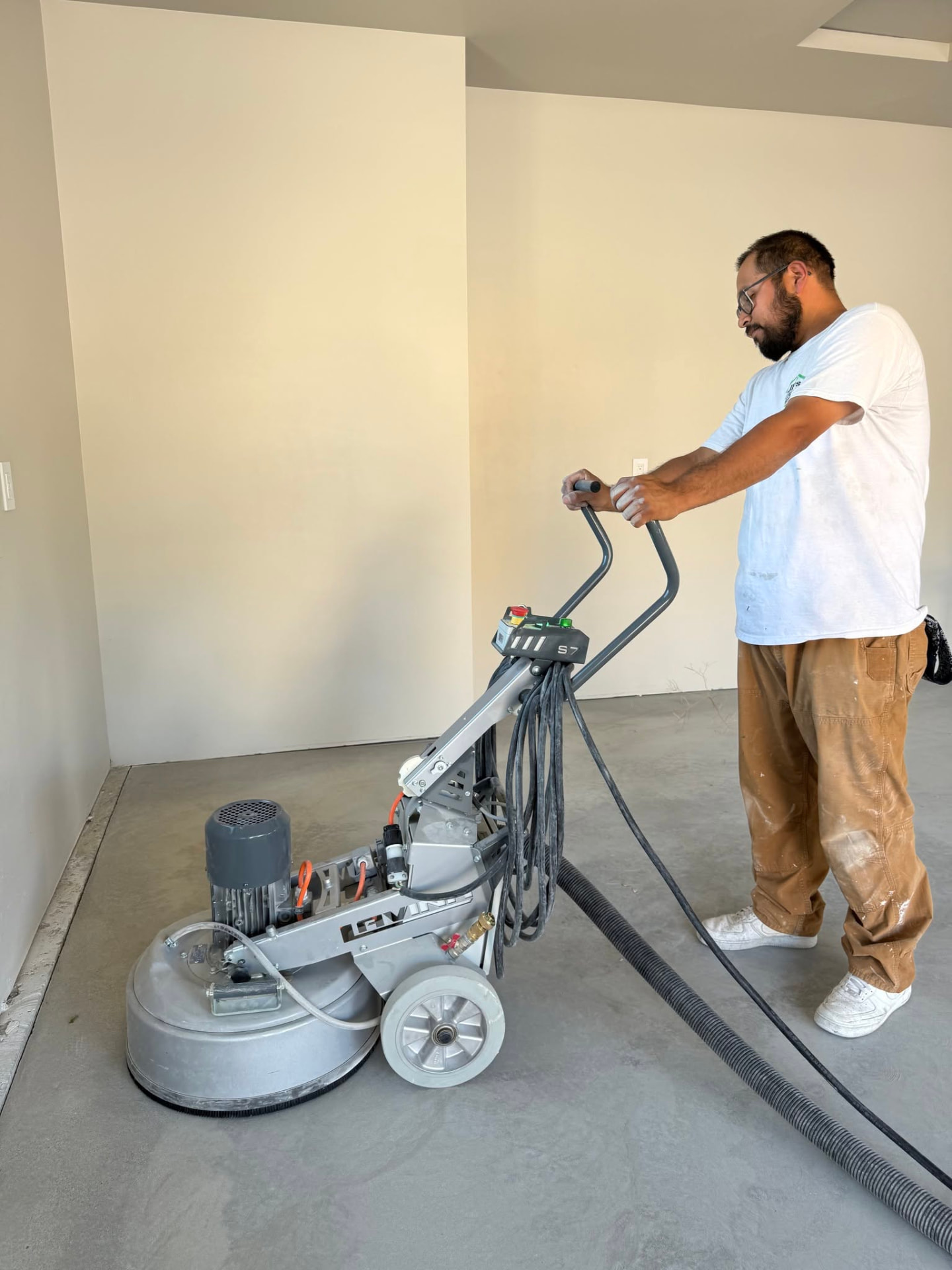 Tony Perez grinding a concrete floor to prep it for epoxy coating
