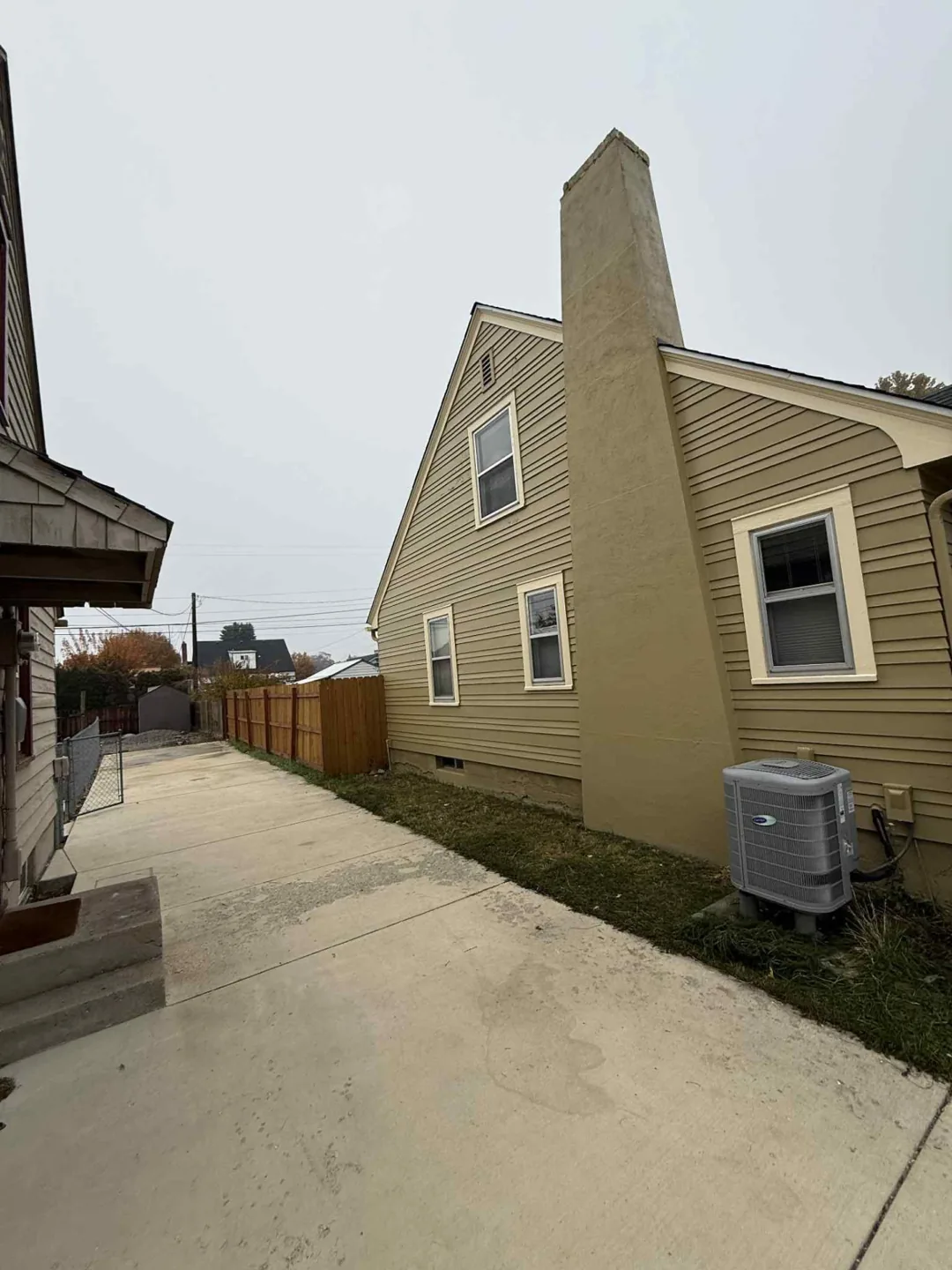 Side view of tan siding with white trim
